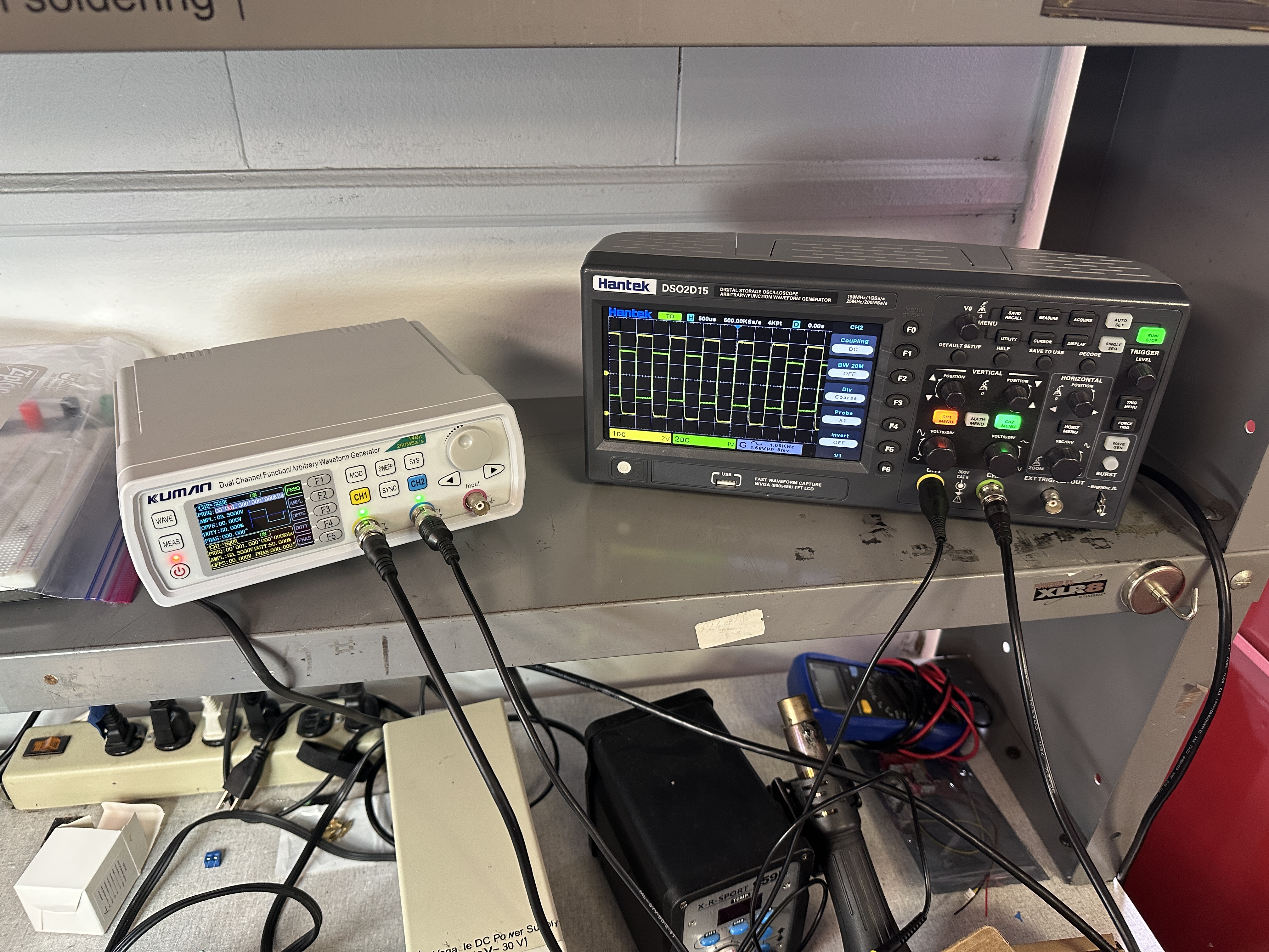 Kuman dual-channel function generator and Hantek DSO2D15 oscilloscope on the bench